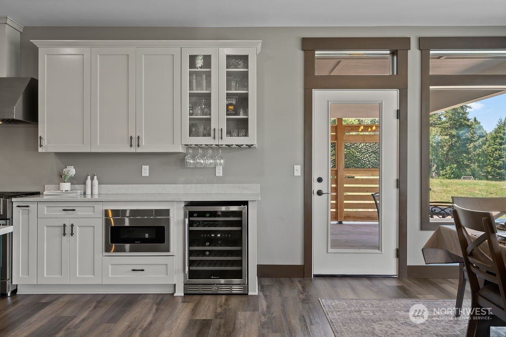 1450 Old Cedars Road Cle Elum, WA 98922 - Photo 12 of 40 a kitchen with stainless steel appliances a stove and white cabinets with wooden floor