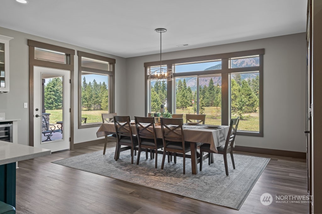 1450 Old Cedars Road Cle Elum, WA 98922 - Photo 14 of 40 a view of a dining room with furniture window and wooden floor