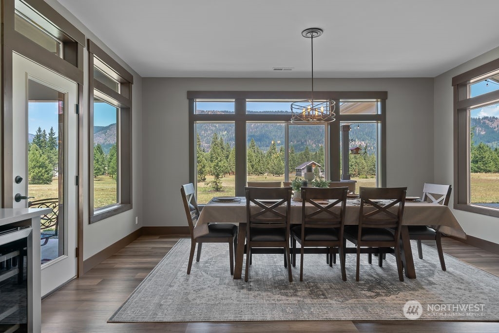 1450 Old Cedars Road Cle Elum, WA 98922 - Photo 15 of 40 a view of a dining room with furniture window and wooden floor