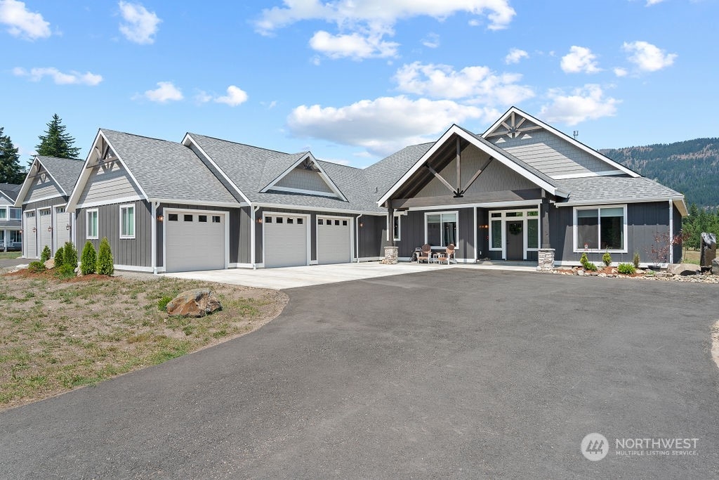 1450 Old Cedars Road Cle Elum, WA 98922 - Photo 2 of 40 a front view of a house with a garden
