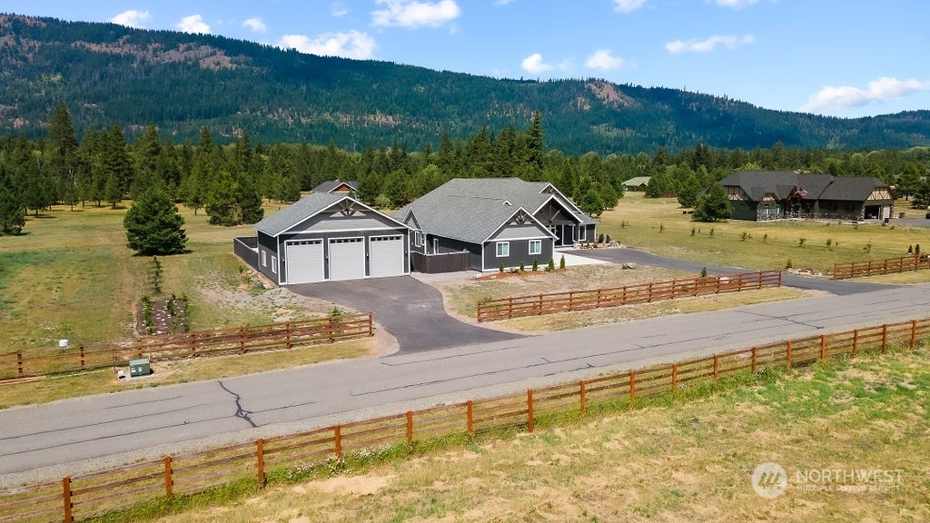 1450 Old Cedars Road Cle Elum, WA 98922 - Photo 35 of 40 a view of a lake with a house in the background