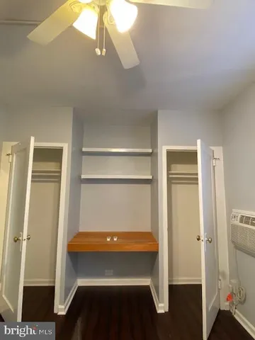 a room with a bed and cabinets