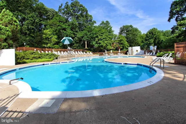 a view of a swimming pool with an outdoor seating