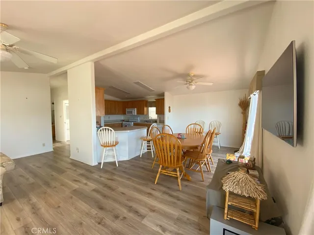 a dining room with furniture and wooden floor
