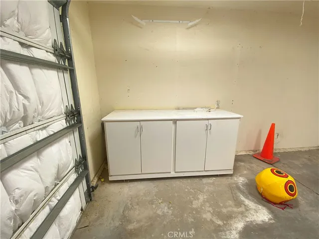 a view of storage and utility room with two washing machine