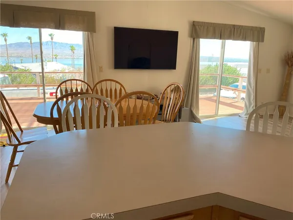 a view of a livingroom with furniture and floor to ceiling window