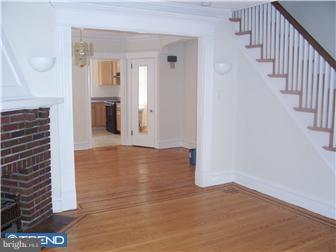 328 Kingston Road Upper Darby, PA 19082 - Photo 2 of 12 a view of a hallway with wooden floor and staircase