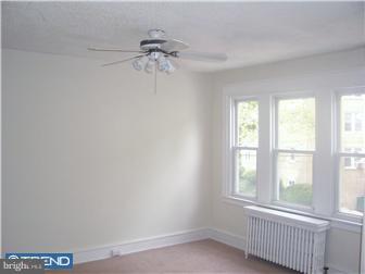 328 Kingston Road Upper Darby, PA 19082 - Photo 11 of 12 an empty room with windows and fan