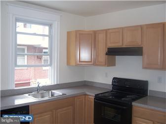 328 Kingston Road Upper Darby, PA 19082 - Photo 7 of 12 a kitchen with granite countertop a sink a stove and cabinets