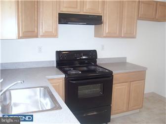 328 Kingston Road Upper Darby, PA 19082 - Photo 8 of 12 a kitchen with granite countertop a stove and a sink