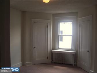 328 Kingston Road Upper Darby, PA 19082 - Photo 10 of 12 a view of an empty room with a window