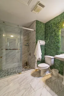 a bathroom with a toilet sink and shower