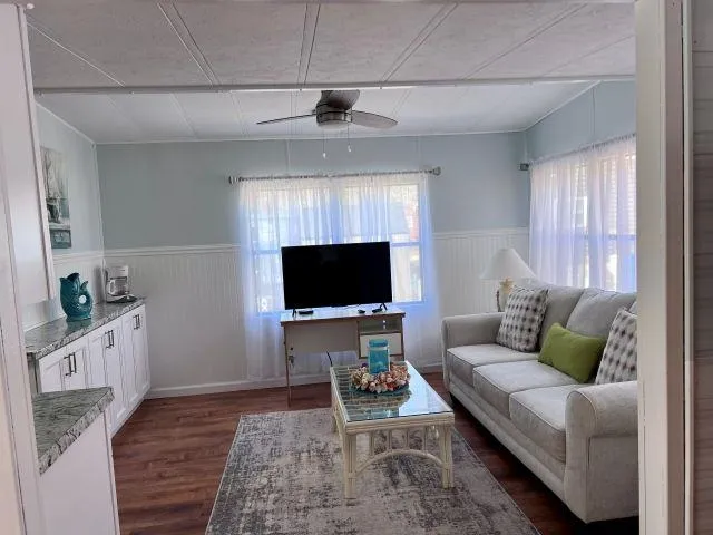 a living room with furniture and a flat screen tv