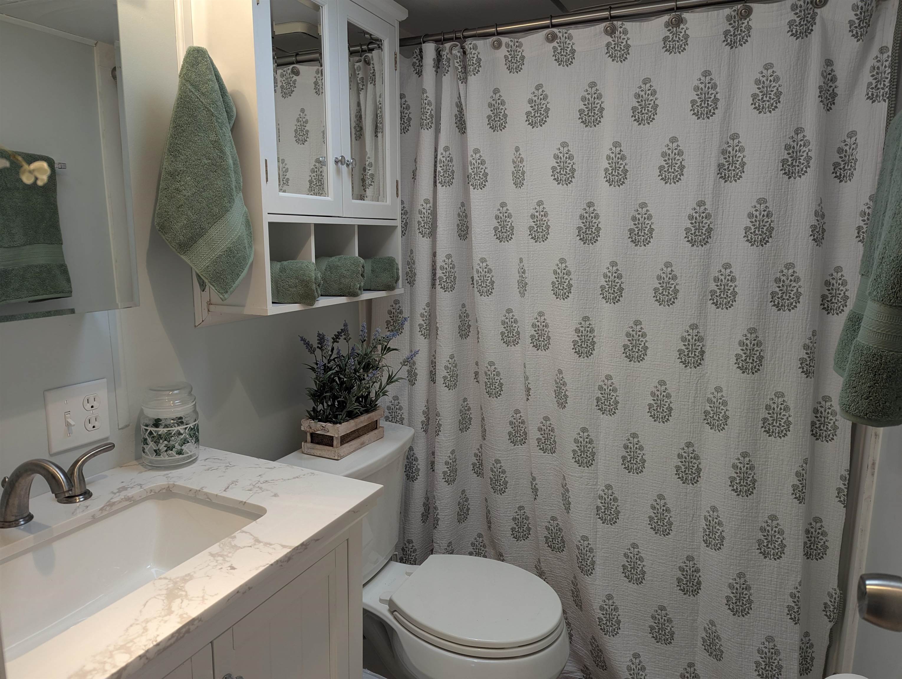 209 Horseshoe, Unit 209 Ocean View, NJ 08246 - Photo 13 of 19 a bathroom with a granite countertop sink and a toilet