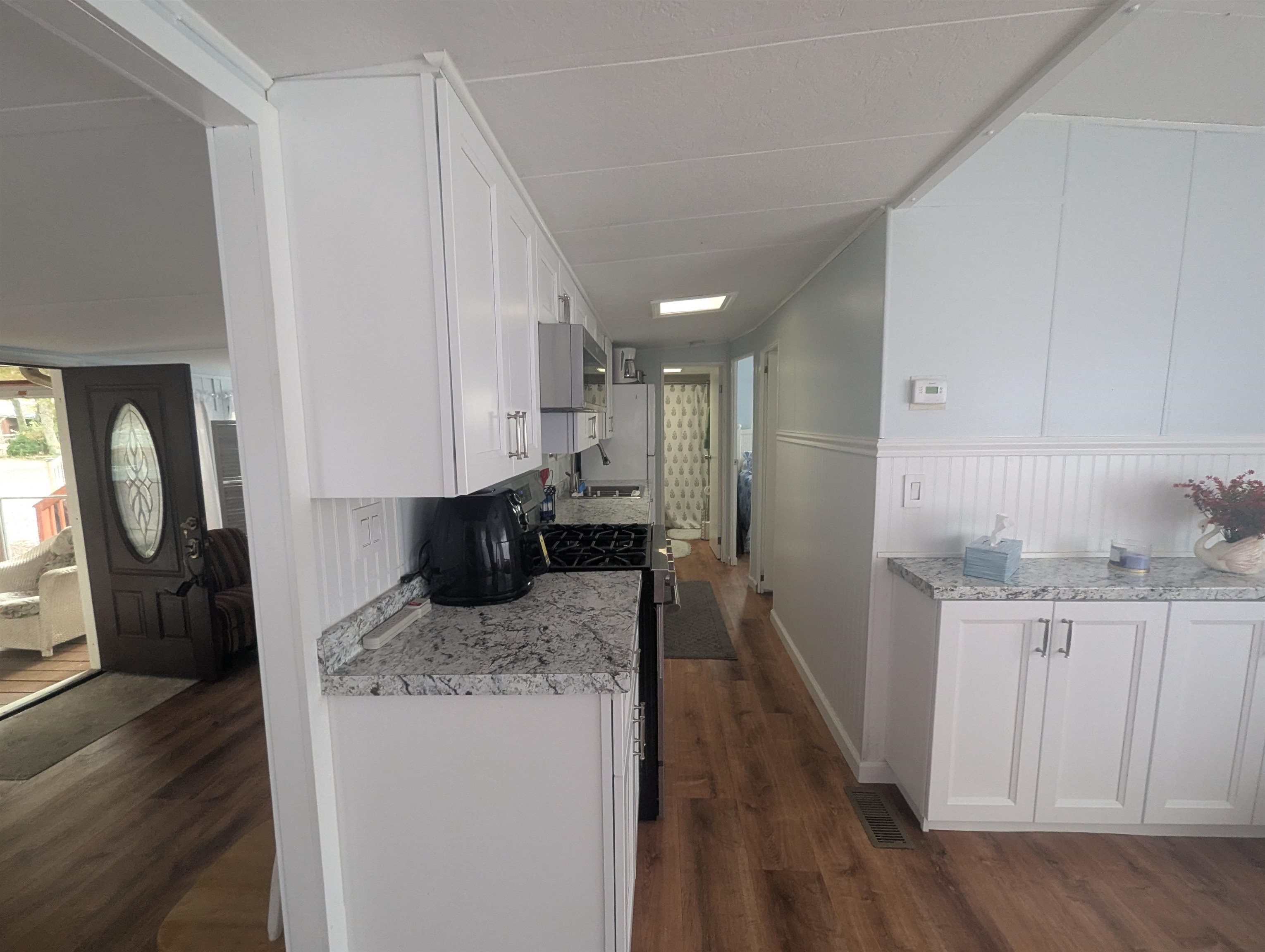 209 Horseshoe, Unit 209 Ocean View, NJ 08246 - Photo 7 of 19 a kitchen with granite countertop a sink a stove and refrigerator