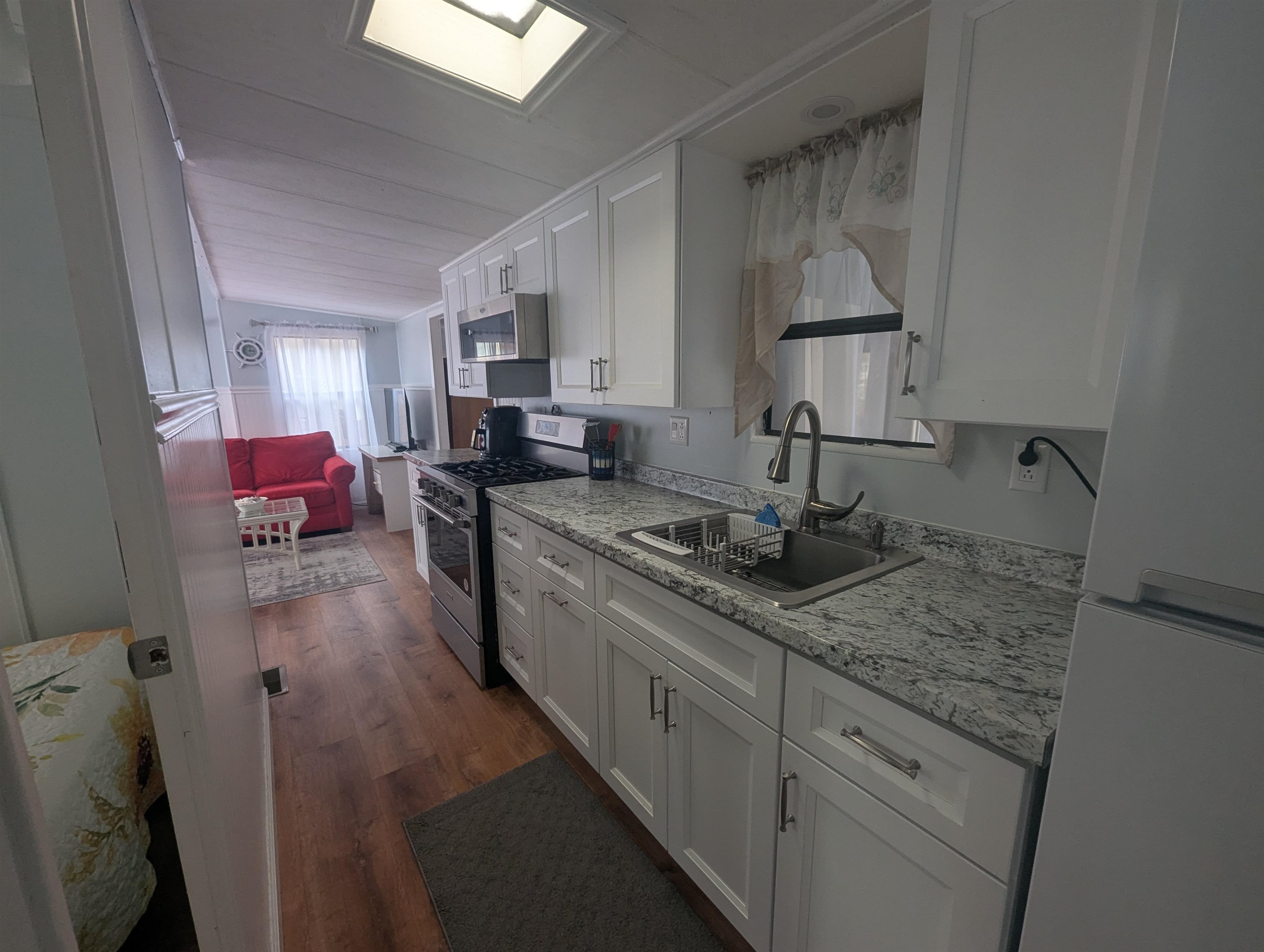 209 Horseshoe, Unit 209 Ocean View, NJ 08246 - Photo 9 of 19 a kitchen with sink refrigerator and cabinets