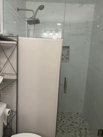 a bedroom with a bed and painting on the wall