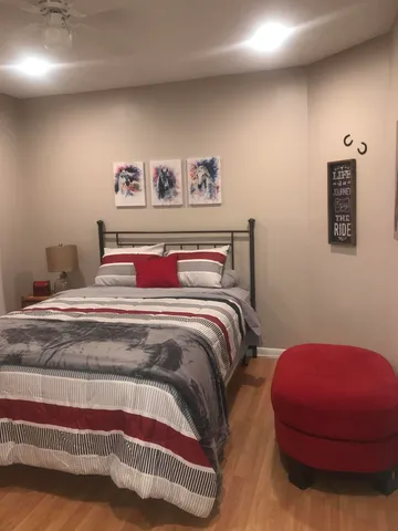 a bedroom with a bed and a mirror
