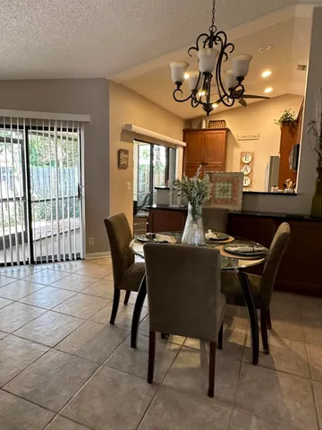 a kitchen with kitchen island granite countertop a sink and a refrigerator