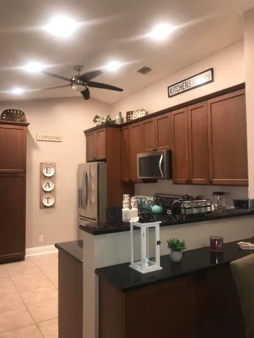 a kitchen with stainless steel appliances a refrigerator and a stove
