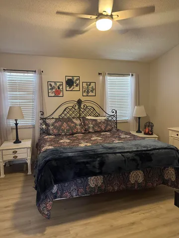 a bedroom with a large bed and a chandelier