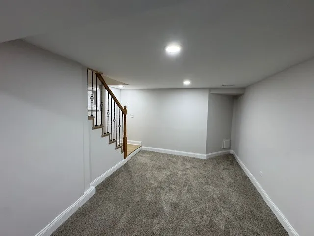 a view of an empty room with stairs