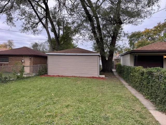 a view of backyard of house with green space