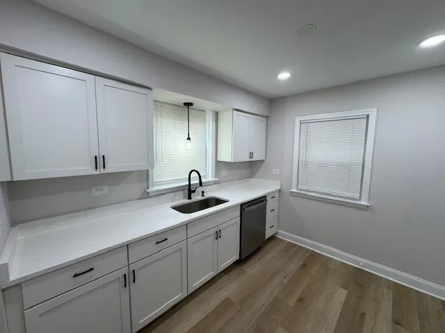 a kitchen with sink and cabinets