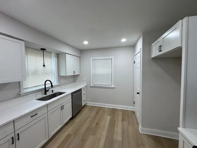 a kitchen with sink and cabinets