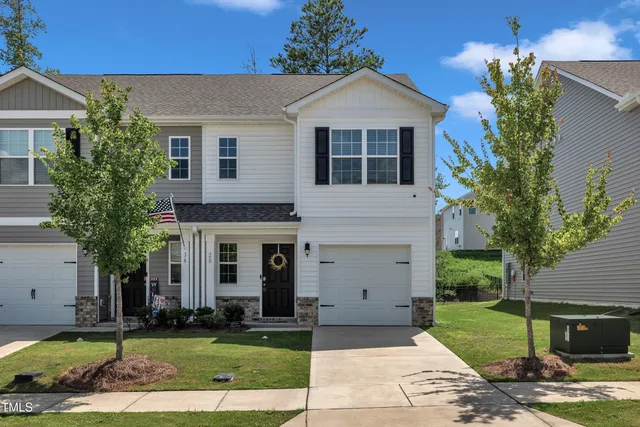 a front view of a house with a yard