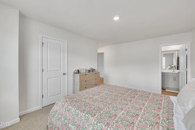 a bedroom with a bed and cabinets