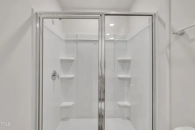 a bathroom that has a glass shower door