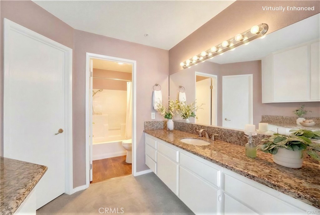 104 South Cross Creek Road, Unit M Orange, CA 92869 - Photo 15 of 34 a spacious bathroom with a granite countertop sink and a mirror