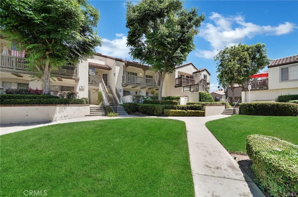 104 South Cross Creek Road, Unit M Orange, CA 92869 - Photo 21 of 34 a front view of house with yard and green space