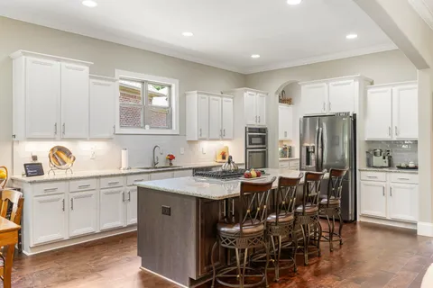 a kitchen with a table chairs refrigerator and cabinets