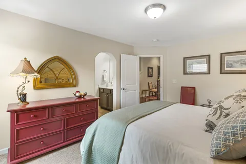 a bedroom with a bed and a dresser