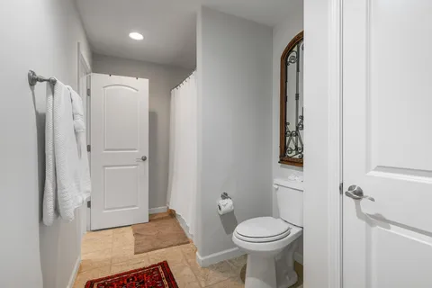 a bathroom with a toilet and a shower