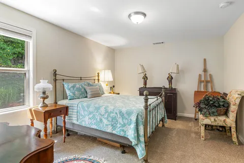 a bedroom with a bed and a table