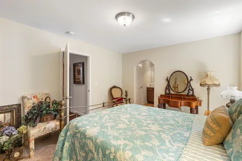 a bedroom with a bed and a large mirror