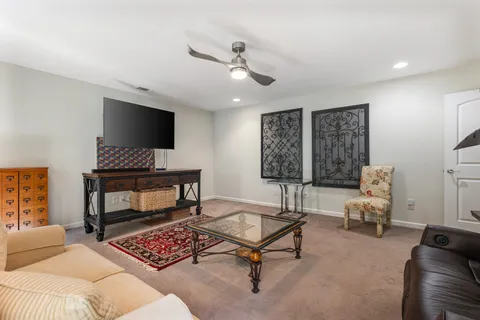 a living room with furniture a flat screen tv and a fireplace