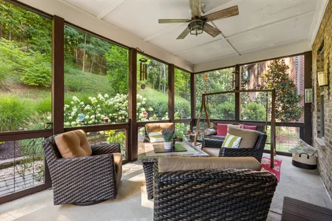 a living room with furniture and a floor to ceiling window