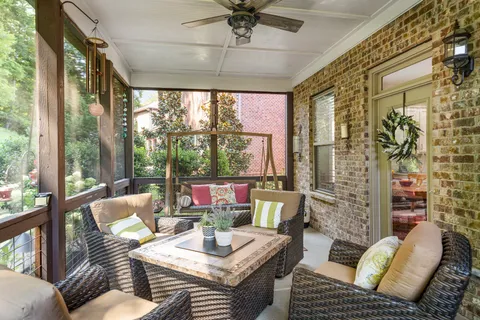 a living room with furniture and a floor to ceiling window