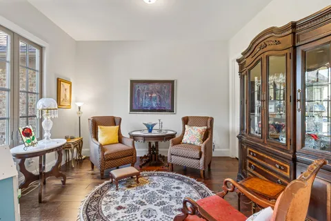 a living room with furniture two lamps and a rug