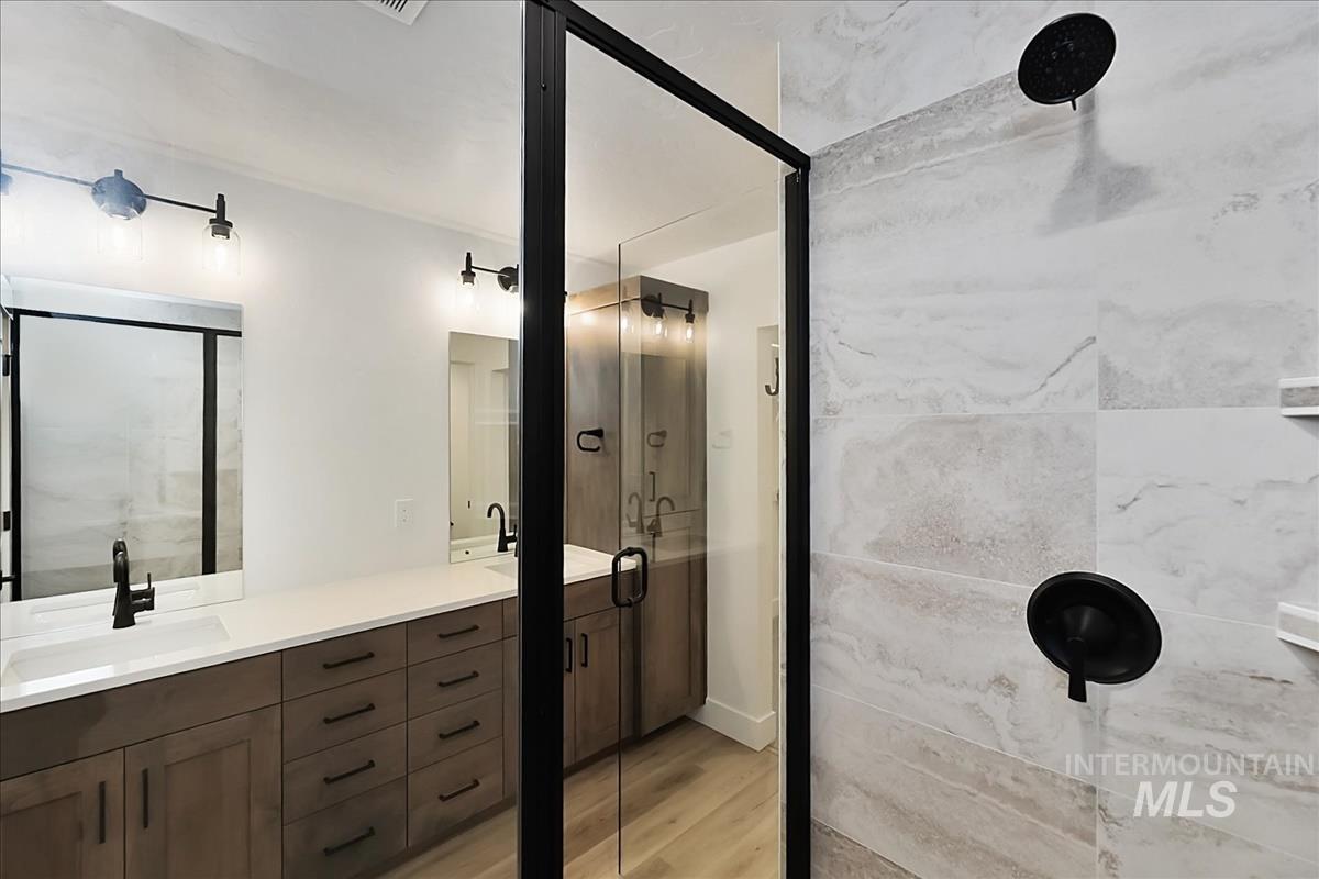 776 South Calhoun Lane Star, ID 83669 - Photo 31 of 49 Contemporary bathroom featuring a spacious dual vanity with wood-finish cabinetry and white countertops