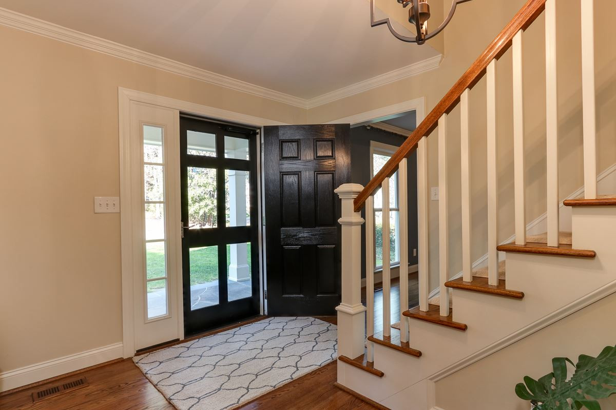 7009 North Ridge Drive Raleigh, NC 27615 - Photo 3 of 25 Foyer showcases staircase and sight lines to family room with spectacular golf course view Foyer
