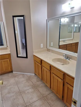 a bathroom with a sink vanity and mirror