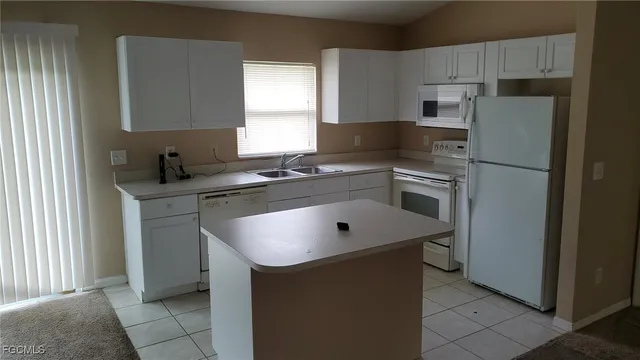 a kitchen with a sink stove and refrigerator