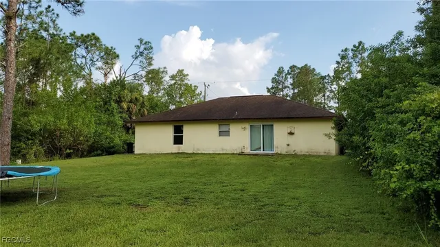 a view of a house with a yard and sitting area