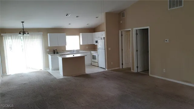 a kitchen with kitchen island stainless steel appliances a sink stove and refrigerator