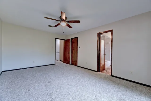 a view of a livingroom with a ceiling fan and window